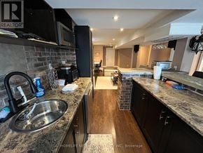 Oshawa (Taunton) apartment for rent - A kitchen with granite countertops and a sink.