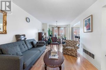 Toronto (West Humber-Clairville) townhouse for rent - A living room with a grey couch, a brown coffee table, and a painting on the wall.
