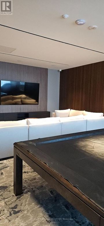 Milton (Tm Timberlea) condo for rent - A modern living room with a white couch and a wooden coffee table.