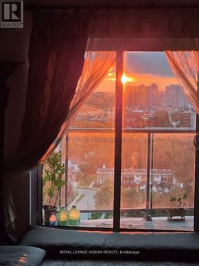 Toronto (Wexford-Maryvale) condo for rent - A sunset view from a room with a window overlooking a cityscape.