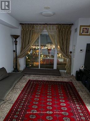 Toronto (Wexford-Maryvale) condo for rent - A living room with a red carpet and a large window.