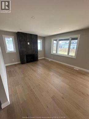 Lasalle apartment for rent - A room with wooden flooring and a large black wardrobe.