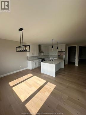 Lasalle apartment for rent - A kitchen with white cabinets and a wooden floor.