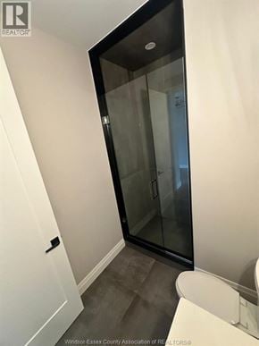 Lasalle apartment for rent - A white bathroom with a glass door and a white toilet.