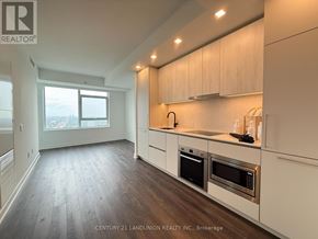 Toronto (North St. James Town) condo for rent - A modern kitchen with white cabinets and stainless steel appliances.