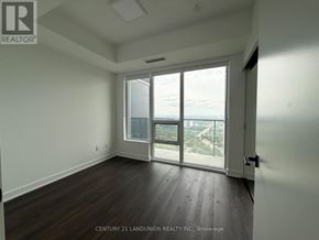 Toronto (North St. James Town) condo for rent - A room with a view of the city through large windows.