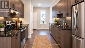 Ottawa townhouse for rent - A modern kitchen with stainless steel appliances and wooden cabinets.