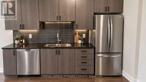 Ottawa townhouse for rent - A kitchen with a sink, dishwasher, and refrigerator.