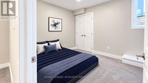 Ottawa townhouse for rent - A bedroom with a bed, pillows, and a framed picture on the wall.