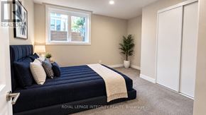 Ottawa townhouse for rent - A bedroom with a bed, a window, and a plant.