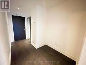 Toronto (Lawrence Park South) condo for rent - A room with a dark blue door and white walls.