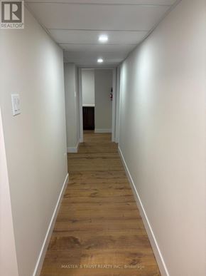 Toronto (Agincourt North) apartment for rent - A long hallway with wood floors and white walls.