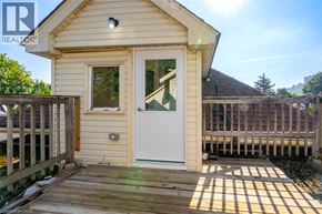 Hamilton apartment for rent - A small house with a white door and a wooden deck.