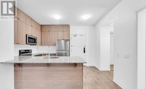 Milton (Walker) condo for rent - A kitchen with a white countertop and wooden cabinets.