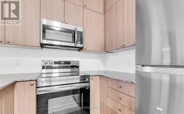 Milton (Walker) condo for rent - A modern kitchen with a stainless steel oven and microwave.