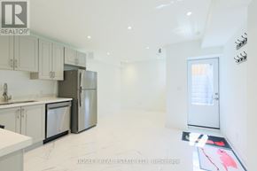 Toronto (Blake-Jones) apartment for rent - A kitchen with white cabinets and appliances is on the market with Bosley Real Estate.