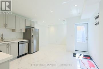 Toronto (Blake-Jones) apartment for rent - A kitchen with white cabinets and appliances is on the market with Bosley Real Estate.