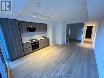 Toronto (Mount Pleasant West) condo for rent - A modern kitchen with wooden floors and a large island.
