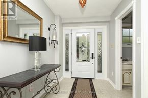 Oakville (Fa Falgarwood) apartment for rent - A hallway with a mirror, a lamp, and a door with a glass panel.