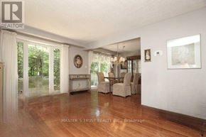Oakville (Fa Falgarwood) apartment for rent - A living room with wood floors and a dining area in the background.