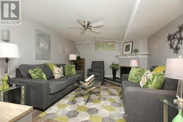 Oakville (Fa Falgarwood) apartment for rent - A living room with a grey couch and a green lamp.
