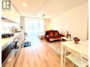 Coquitlam apartment for rent - A well-lit kitchen and living room with a sofa and a dining table.