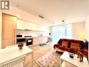 Coquitlam apartment for rent - A living room with a couch and a dining table.