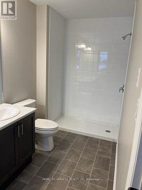 Greater Napanee (Greater Napanee) townhouse for rent - A bathroom with a toilet, sink, and walk-in shower.