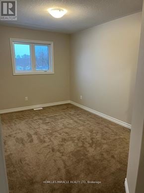 Greater Napanee (Greater Napanee) townhouse for rent - A room with a carpeted floor and a window.