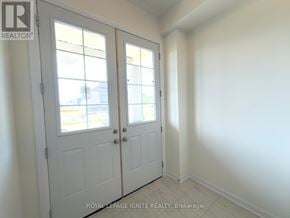 Loyalist (Bath) apartment for rent - A white door with a glass window is in a room with white walls.