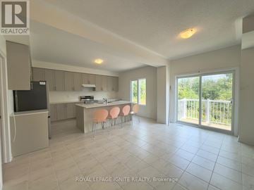 Loyalist (Bath) apartment for rent - A spacious kitchen and dining area with a television and sliding glass doors.