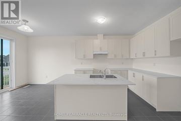 Loyalist (Bath) apartment for rent - A spacious kitchen with white cabinets and a large island.