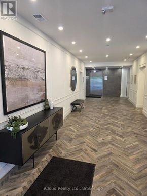 London North (North R) condo for rent - A hallway with a wooden floor and a large painting on the wall.
