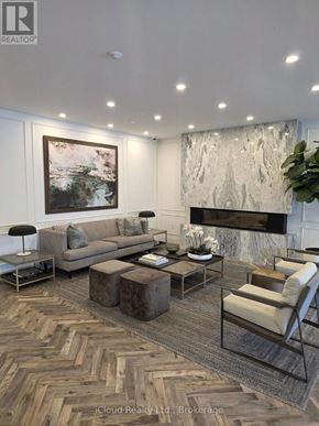 London North (North R) condo for rent - A living room with a grey sofa, a coffee table, and a fireplace.
