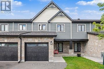 Clarence-Rockland townhouse for rent - A house with a garage and a red bench outside.