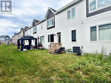 Ottawa townhouse for rent - A realtor photo of a house with a gazebo and a deck.