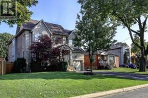Toronto (Islington-City Centre West) apartment for rent - A large house with a well-maintained lawn in front.
