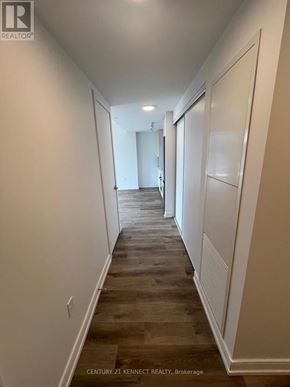 Hamilton (Beasley) condo for rent - A long hallway with wood floors and white walls.