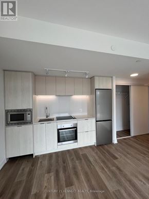 Hamilton (Beasley) condo for rent - A modern kitchen with wooden floors and white cabinets.