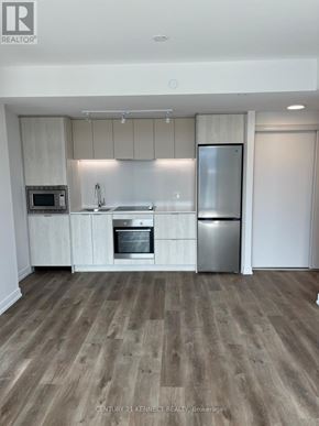 Hamilton (Beasley) condo for rent - A modern kitchen with wooden floors and stainless steel appliances.