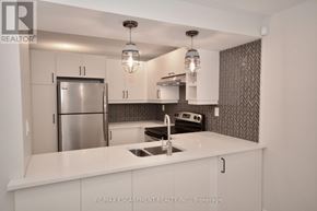 Hamilton (Mountview) apartment for rent - A modern kitchen with white cabinets and a stainless steel refrigerator.