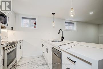 Toronto (The Beaches) multi-family for rent - A white kitchen with a sink and a window.
