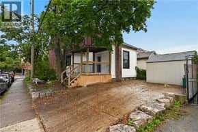 Hamilton apartment for rent - A house with a driveway and a tree in front.