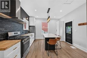 Hamilton apartment for rent - A modern kitchen with a wooden island and a dining area.