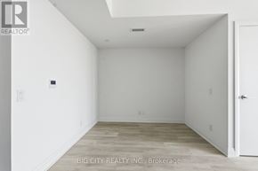 Toronto (Thorncliffe Park) condo for rent - A room with white walls and a wooden floor.