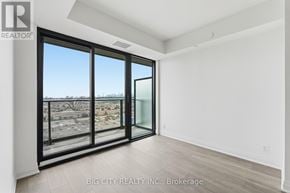 Toronto (Thorncliffe Park) condo for rent - A room with a view of a parking lot through the window.