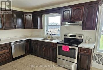 Pelham (Fenwick) apartment for rent - A kitchen with dark wood cabinets and a stainless steel dishwasher.