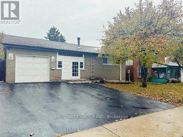 Toronto (Agincourt South-Malvern West) apartment for rent - A house with a garage and a tree in front of it.