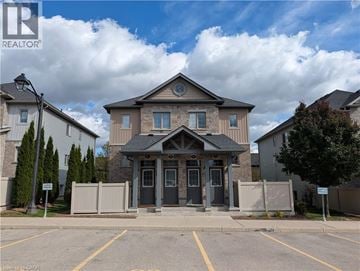 Kitchener townhouse for rent - A building with a grey front and a sign that says REALTOR.