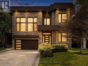 Toronto (Newtonbrook East) apartment for rent - A modern house with a stone facade and a garage door numbered 133.